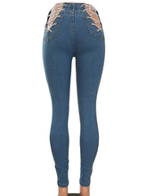 Pantalones ajustados ajustados con cordones cruzados de mezclilla